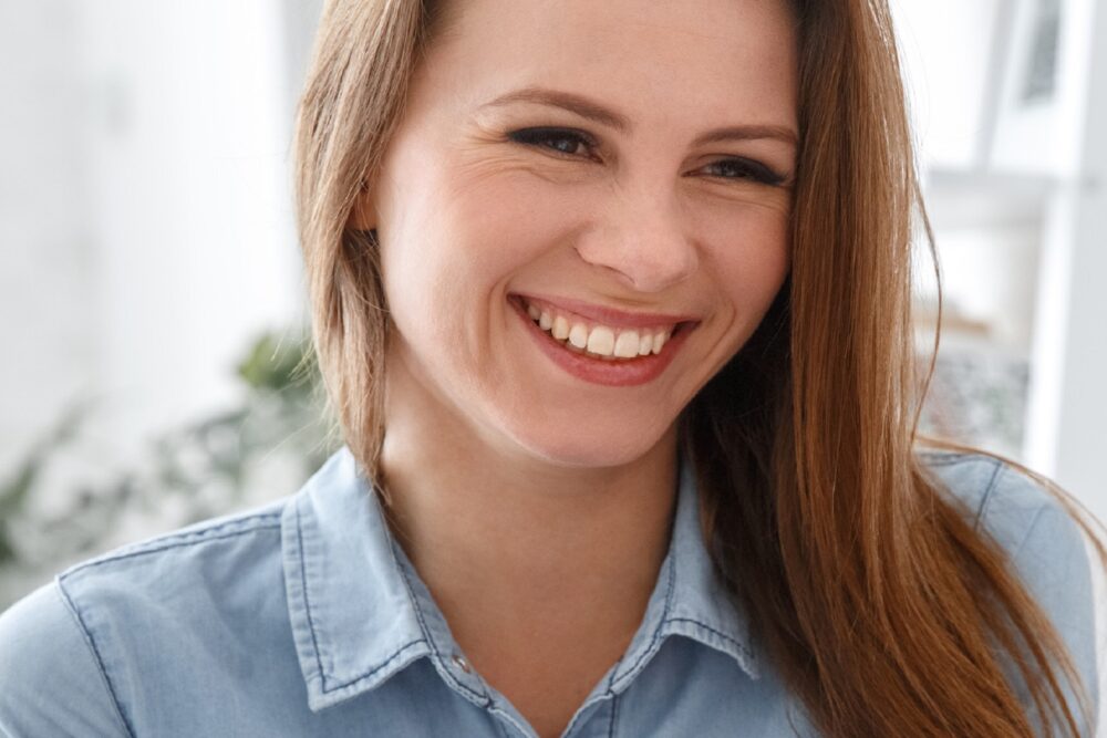 woman smiling wearing blue shirt