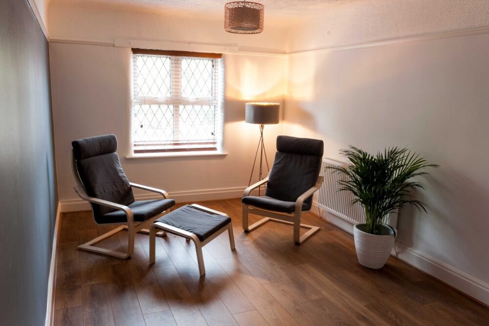 Two chairs facing each other in a therapy room
