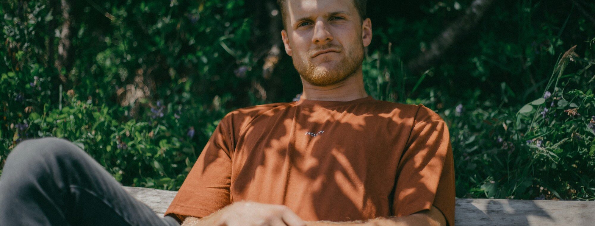 man sitting on a bench looking into the camera