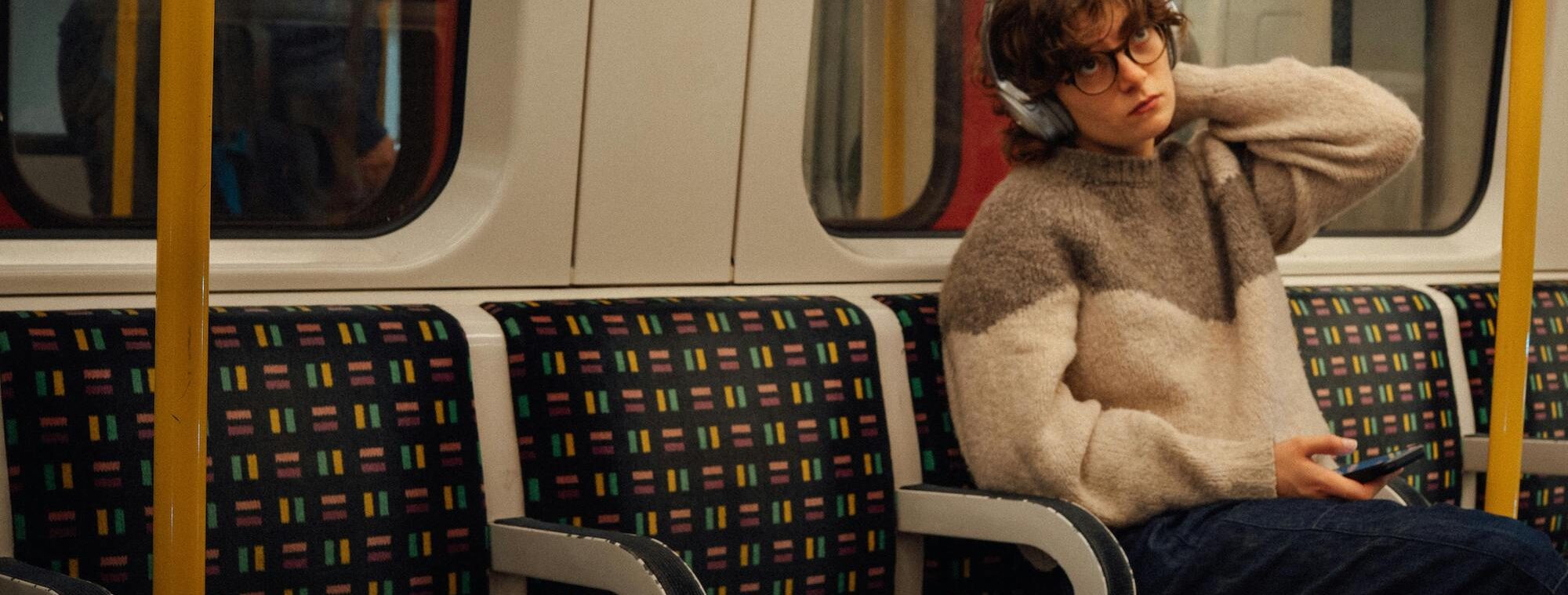 a woman sitting on her own on a train