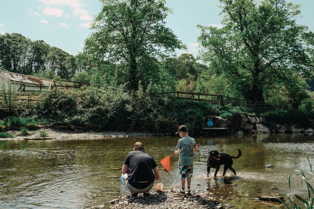 Father and son fishing in a river