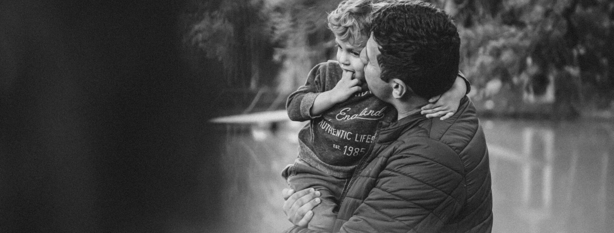 A father holds his young son