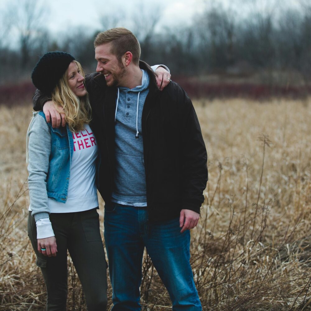 A couple with their arms around each other