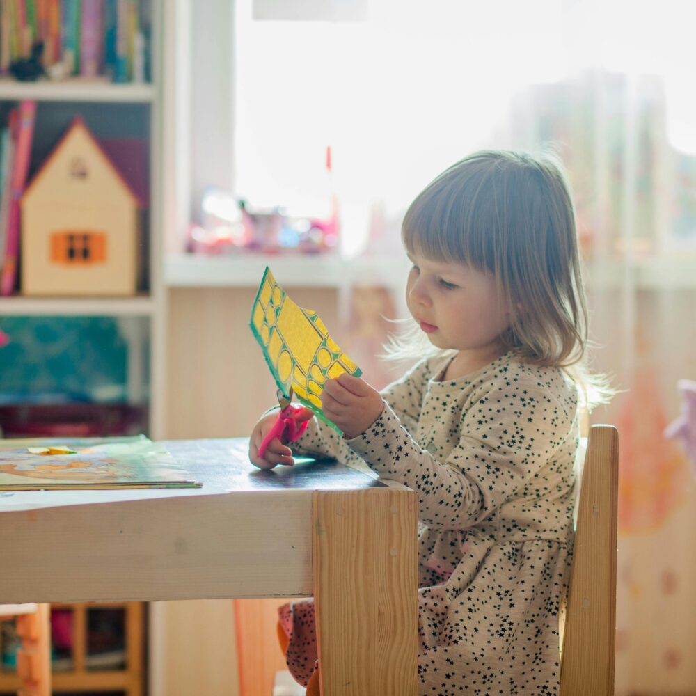 A young girl doing crafts