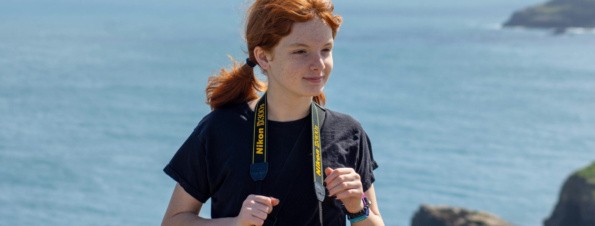 Young girl with a camera around her neck