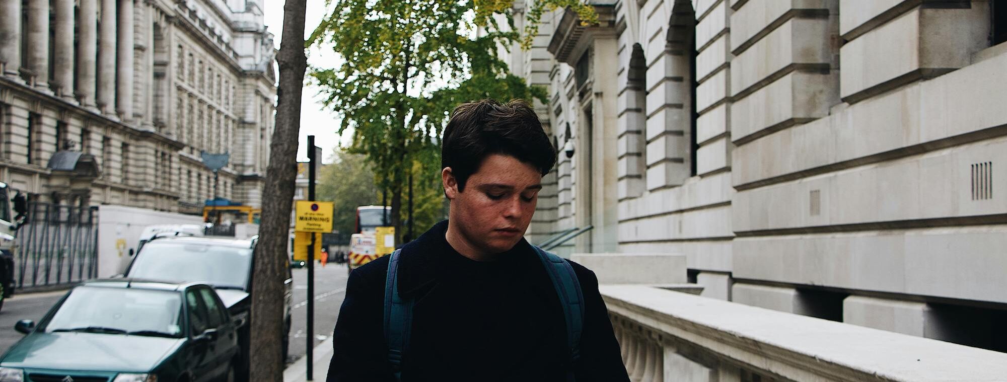 A young man walking on the street