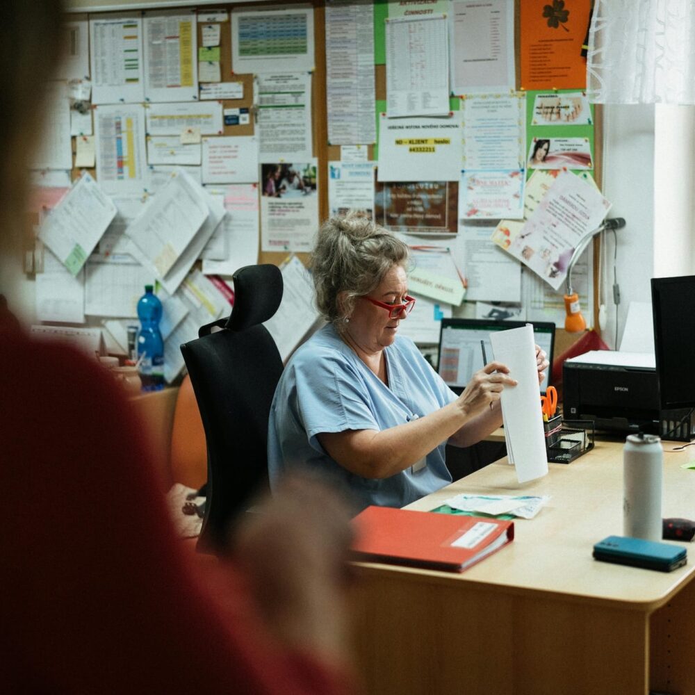 A health professional sitting at her desk